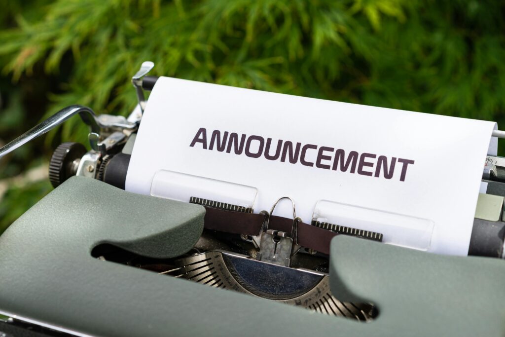 Close-up of a paper labeled 'Announcement' in a typewriter outdoors.